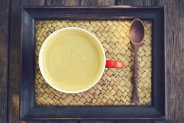 woman holding hot cup of coffee,on table wooden