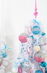White fir-tree with pink and blue Christmas toys