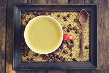 woman holding hot cup of coffee,on table wooden