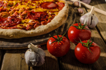 Rustic salami pizza with cheddar cheese and chorizo