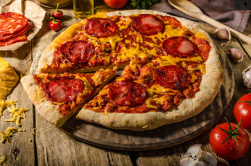 Rustic salami pizza with cheddar cheese and chorizo
