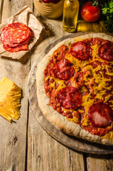 Rustic salami pizza with cheddar cheese and chorizo