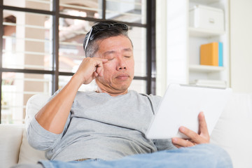 Fototapeta premium asian man with eyes problem after long hours of using computer t