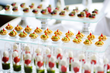 Obraz na płótnie Canvas Plates with assorted snacks on an event party