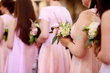 Row of bridesmaids with bouquets at wedding