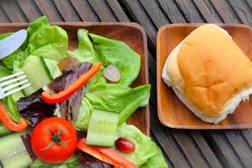 A simple salad with a bread bun