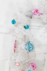 White garland above the fireplace with blue skates and toys