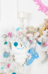 White garland above the fireplace with blue skates and toys
