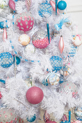 White fir-tree with pink and blue Christmas toys