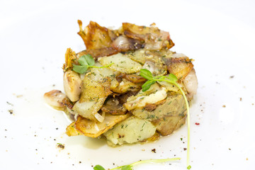 fried potatoes with bacon on a white plate