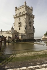 Naklejka premium Belem Tower of Lisbon, Unesco world heritage, with people on the bridge