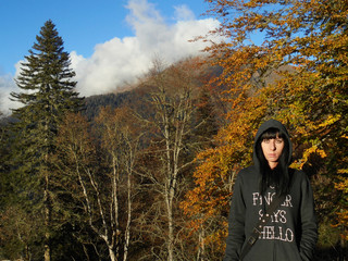 Girl on autumn walk in the Caucasus mountains, beautiful nature