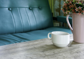 vase of flowers and cup in living room