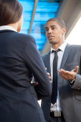 Fototapeta premium Businessman explaining colleague about work, outdoors