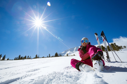 resting female skier in winter resort