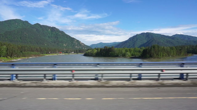 Katun River view from the window of a car moving across the bridge
