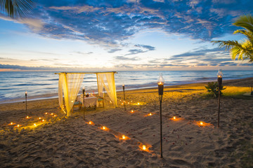 Fototapeta premium dinner set up on the beach sunset time