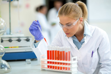 Chemist taking sample with pipette