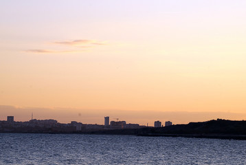 Fototapeta premium The city on the bay at sunset