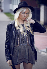 Fototapeta premium Beautiful blonde young girl in posing outdoors