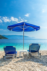 Antisamos beach Kefalonia island, Greece. Parasols and sunbeds on a beautiful beach in Greece.