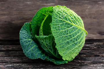 Fototapeta premium Fresh Green cabbage on old wooden table