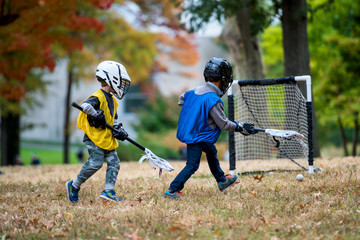Active little kids playing lacrosse - 94796062