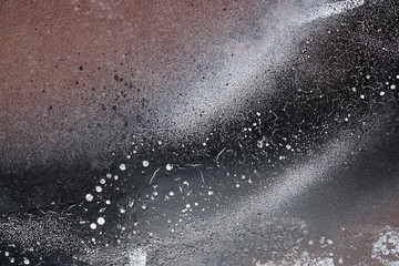 Rust-covered fence  with dripping black and white paint  5