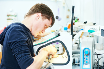 dental technician working with tooth dentures