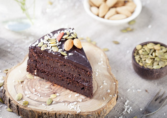 Vegan chocolate beet cake with avocado frosting, decorated nuts, seeds
