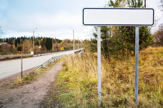 Empty Roadsign Stands Near Rural Highway