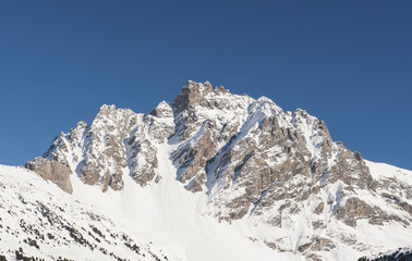 Rocky alpine mountainside in winter