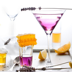 Martini, lavender, honey, lemon cocktail on a white background. Vermouth.