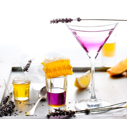 Martini, lavender, honey, lemon cocktail on a white background. Vermouth.