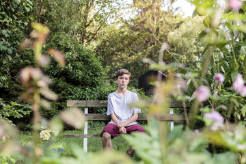 portrait of a teenage boy sitting on a chair