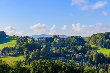 Panoramic landscape of colorful yellow-green hills, blue sky and clouds 