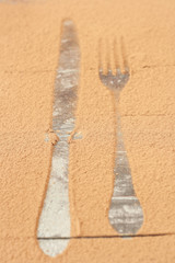 Cocoa scattered on the table, covering cutlery