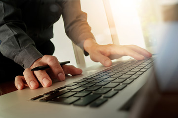 Close up of business man hand working on blank screen laptop com