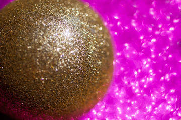 Golden christmas ball on glitter background