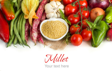 Raw millet in bowl and vegetables