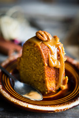 Homemade autumn cake with nuts and caramel on wooden background