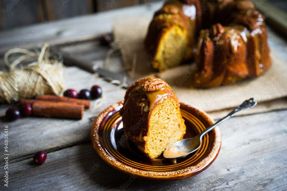 Wall mural homemade autumn cake with nuts and caramel on wooden background