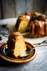 Homemade autumn cake with nuts and caramel on wooden background