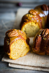 Homemade autumn cake with nuts and caramel on wooden background
