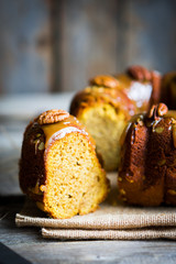 Homemade autumn cake with nuts and caramel on wooden background