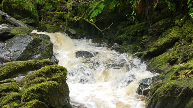 Slow Motion Waterfall over Mossy Rocks