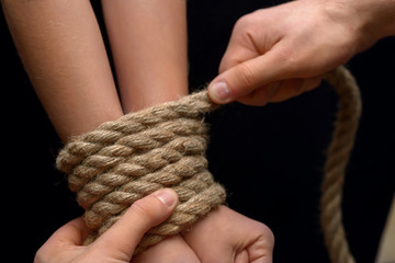 Young girl tied with rope 