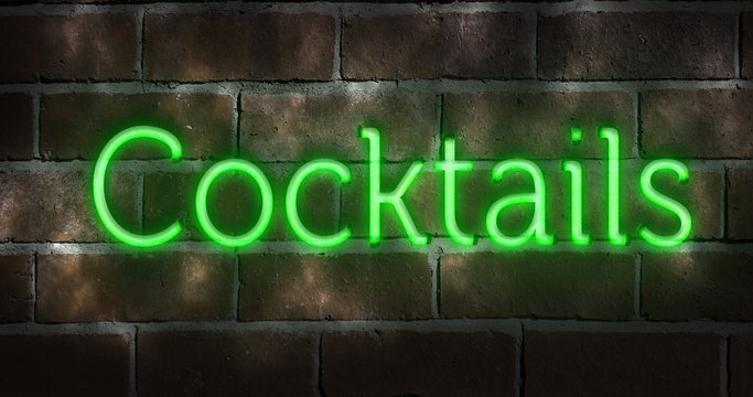 Green neon sign on a brick wall indicating "cocktails"