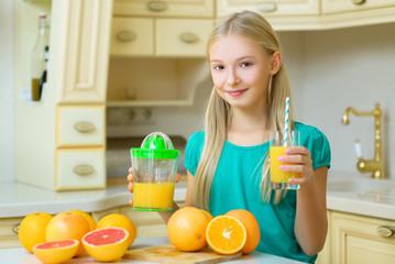Child with oranges. Girl squeezed fresh orange juice