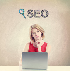 SEO concept with woman working on a laptop